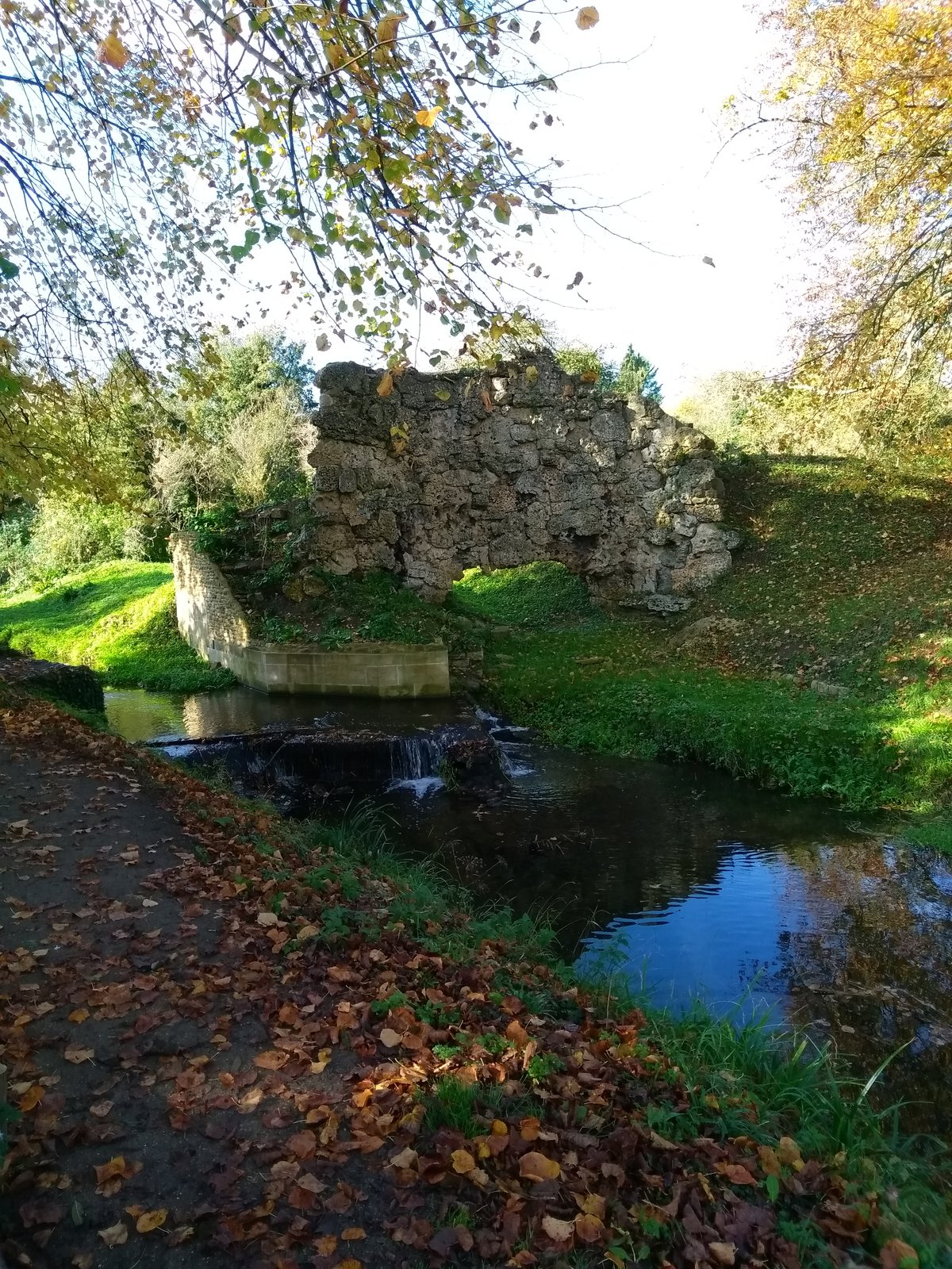 Autumn sun on ruins and a river